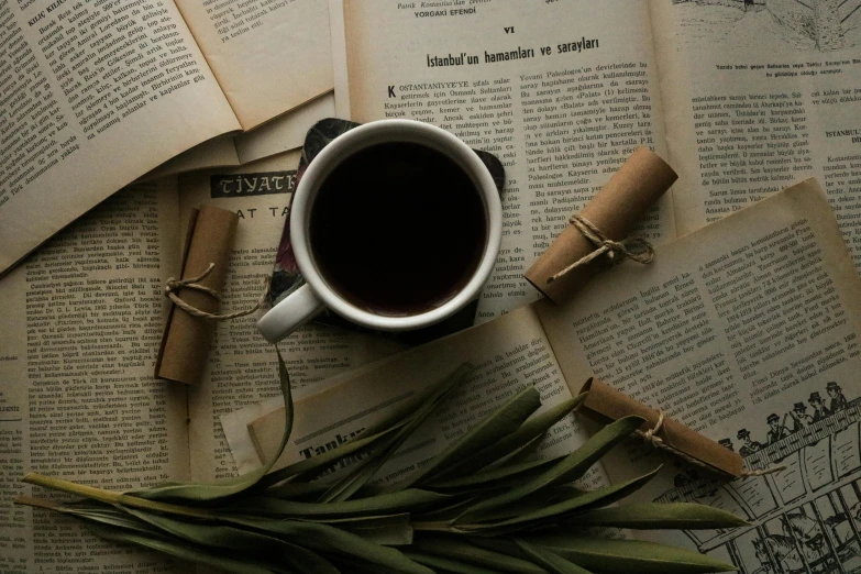 a cup of coffee sits on top of a book