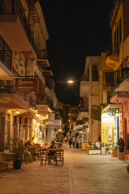 the street is crowded with tables and chairs