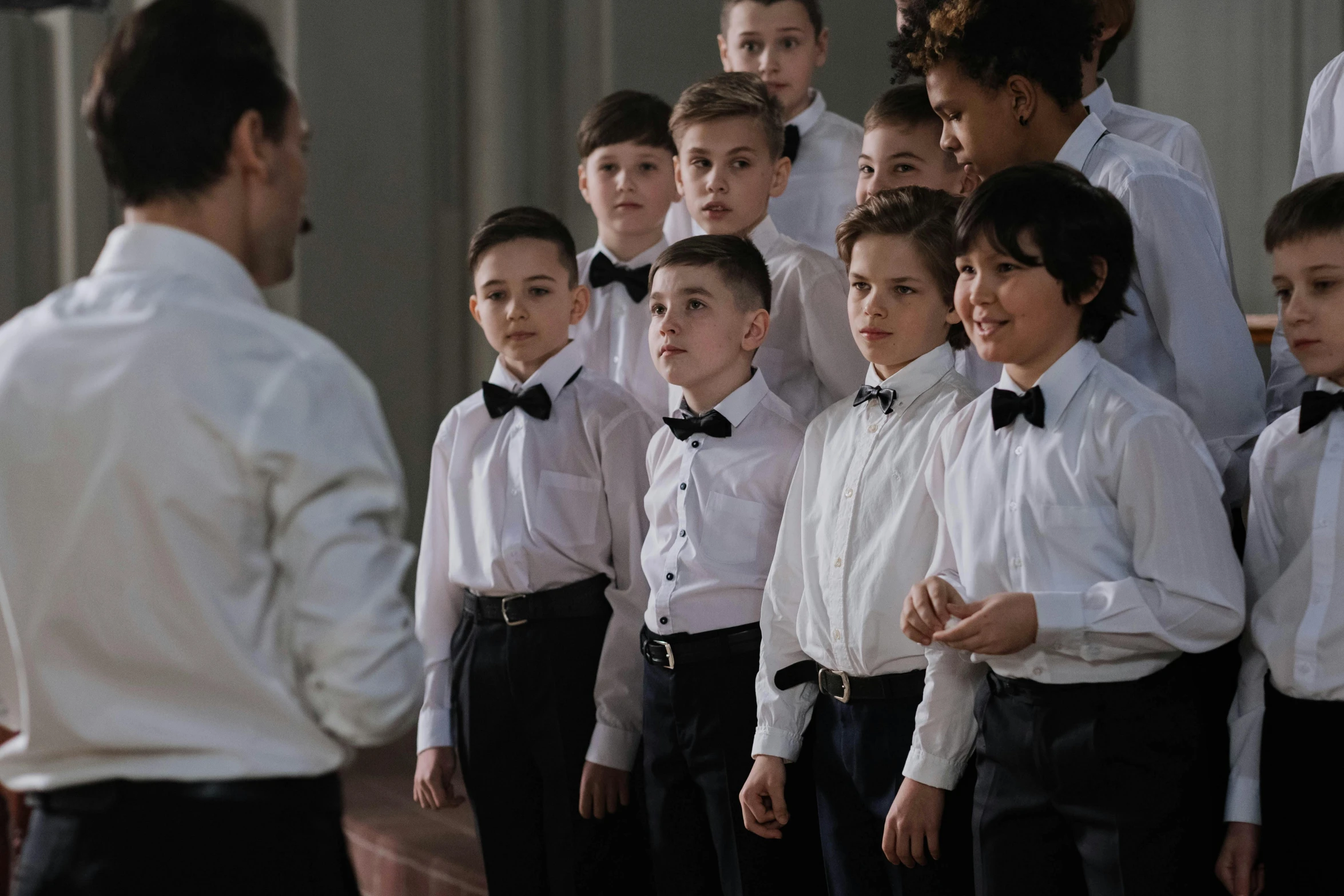 a group of people in formal wear standing together