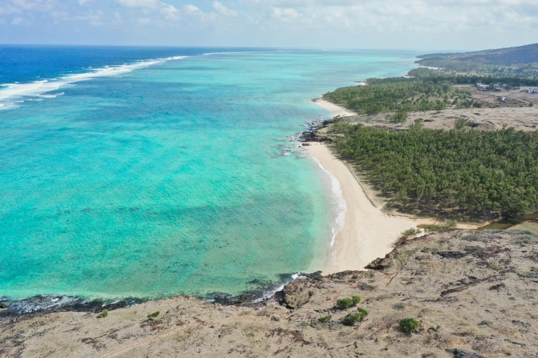 the coast is lined with clear blue water and sandy shore