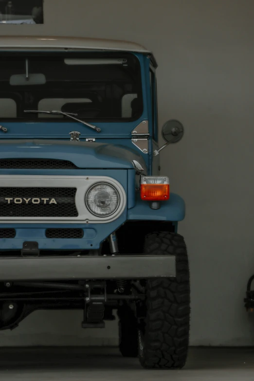 a toyota truck parked in a garage next to a white wall