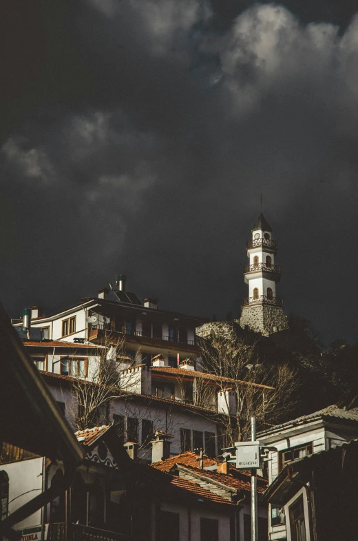 a dark cloudy sky looms over some buildings in a town