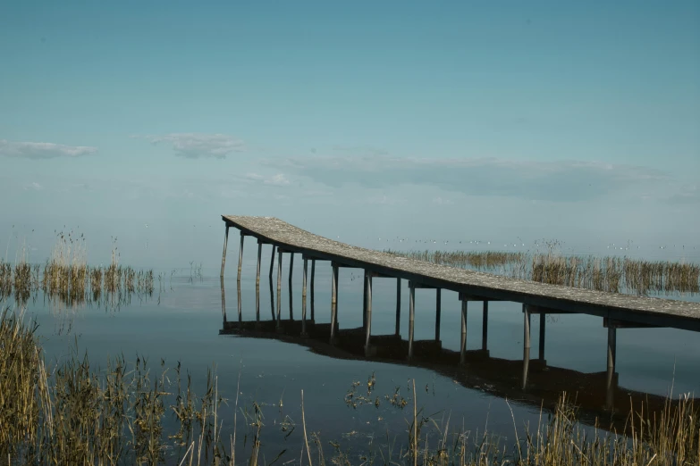 an empty pier sits on the water