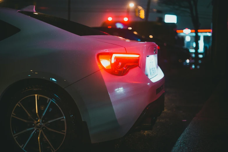 a car parked in front of a street light at night