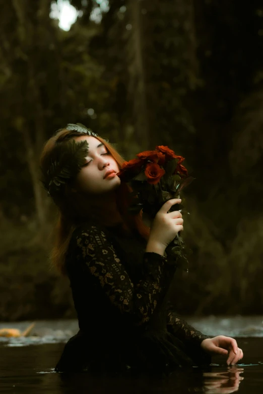 woman in water with flowers in her hair