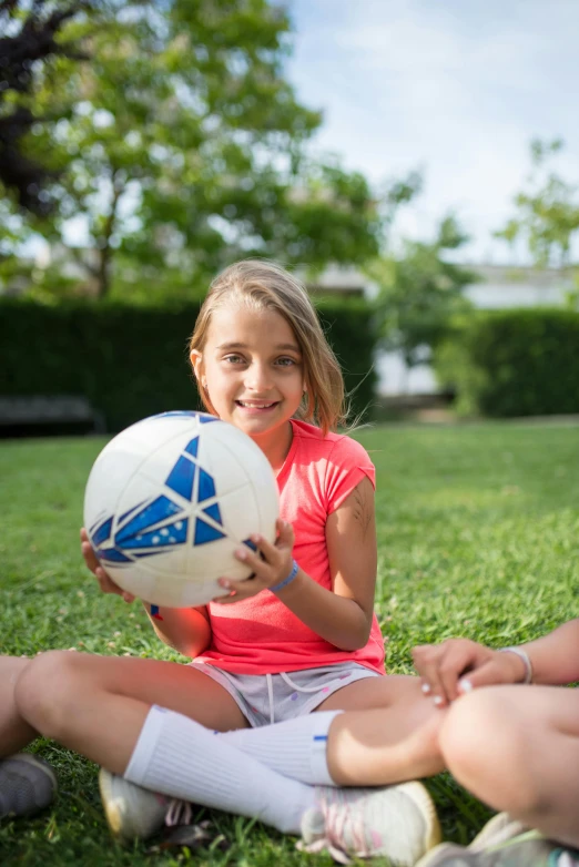 the  is playing with her soccer ball