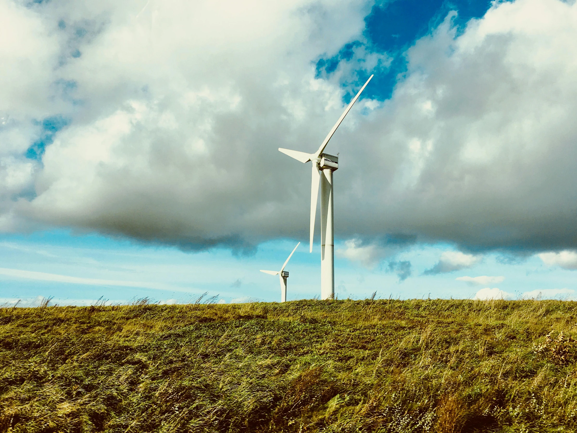 a windmill sits on the side of a hillside