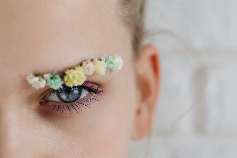 a woman with floral decorations on her eyelashes