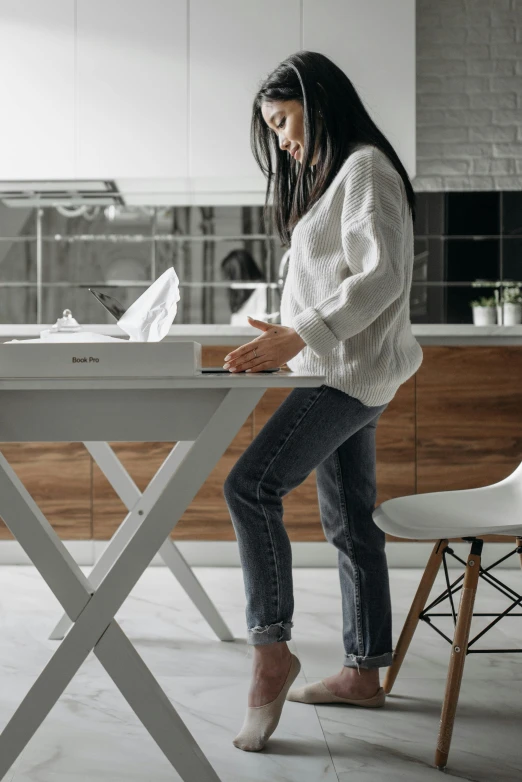 a person sitting at a table using a laptop