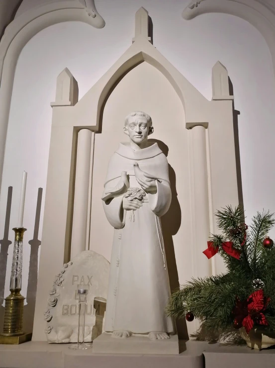 the statue in front of the white church