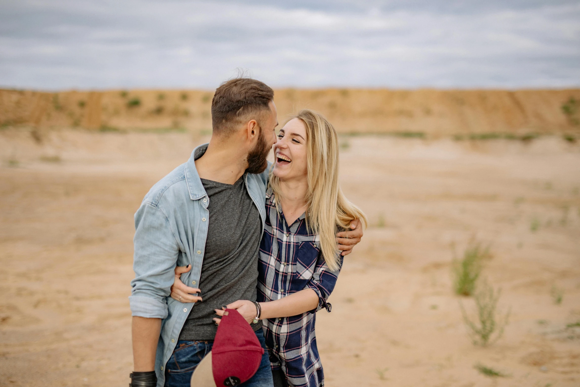 a couple emcing with one another in the desert