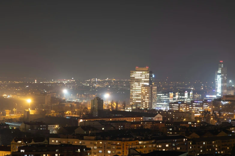 a night scene of an industrial city with skyscrs and buildings