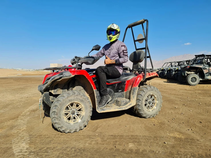 a person riding on the back of an atv