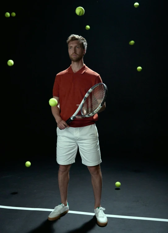 a man standing on a tennis court surrounded by balls