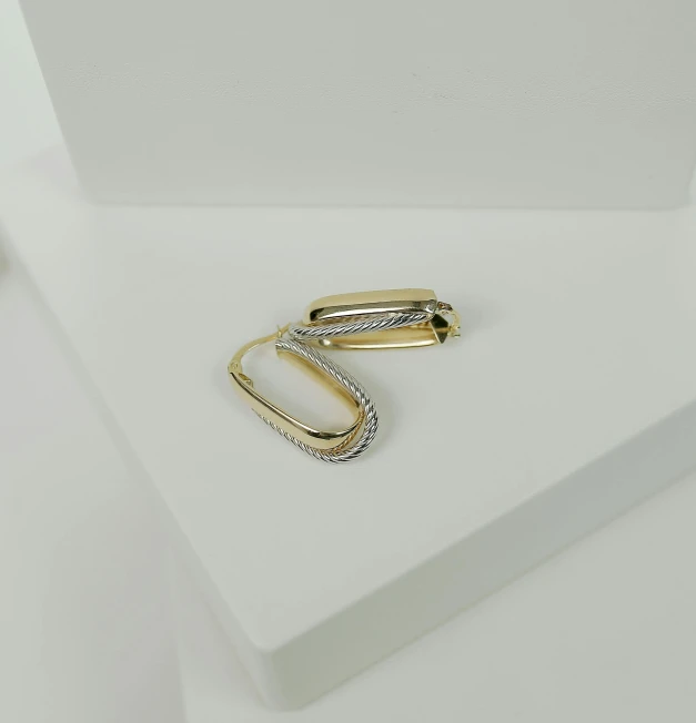 two yellow rings sit on a table next to some papers