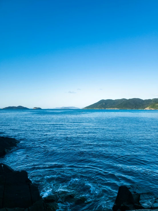 a boat on the water in front of mountains