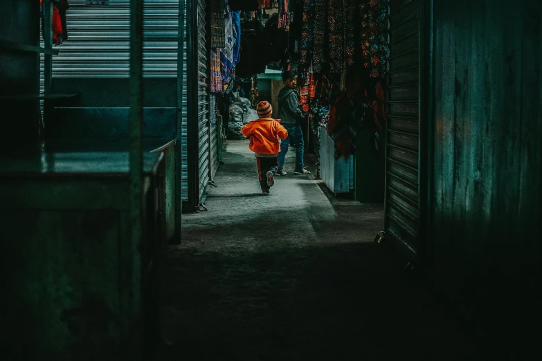 a person walking down an alley in the dark