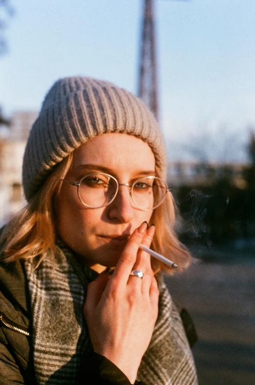 woman smoking cigarette outside with her head tilted backwards