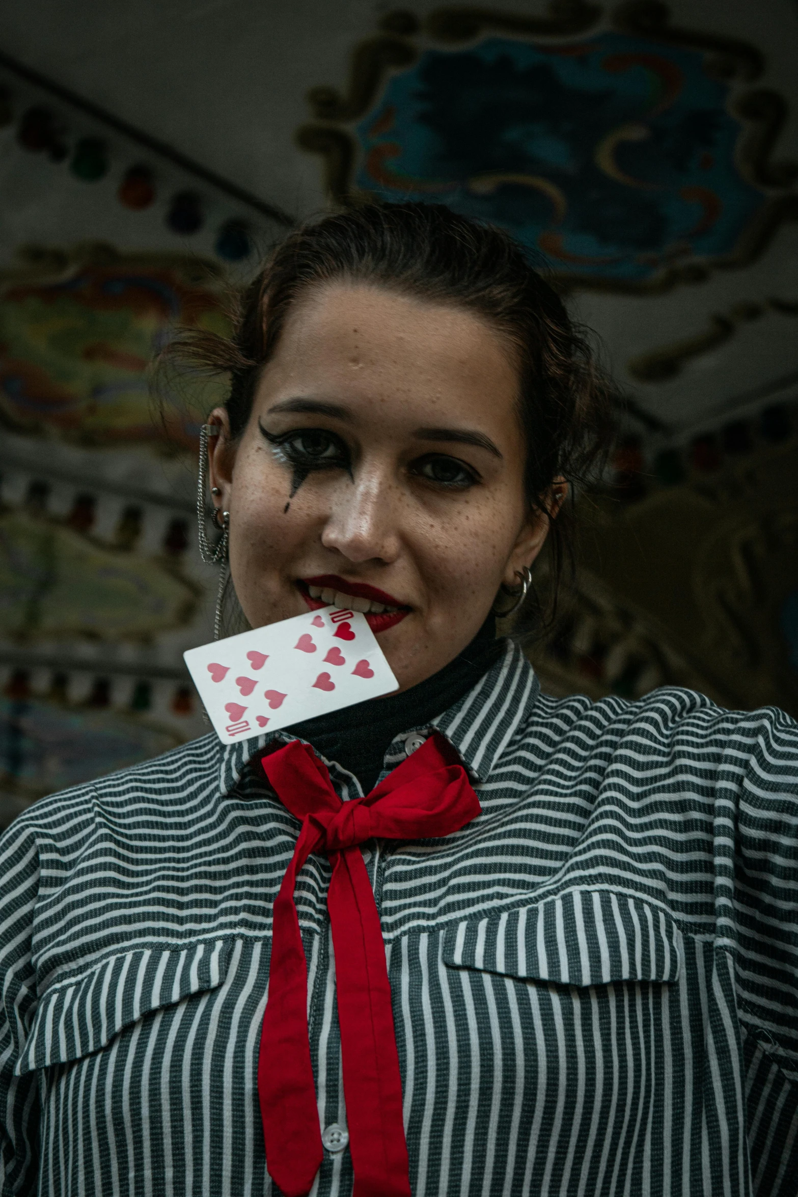 a girl is chewing a card with a tie