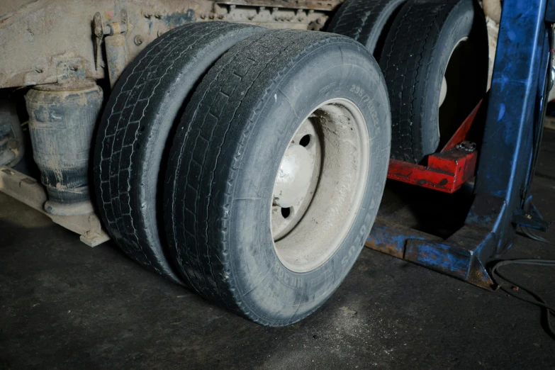 a semi truck with three large tires on it's sides