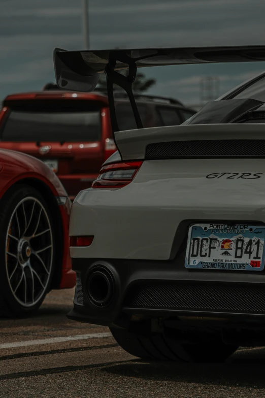 the back end of a grey sports car parked on the road