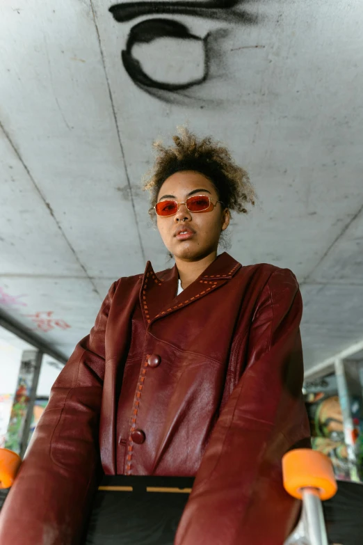 a woman wearing sunglasses with a jacket on