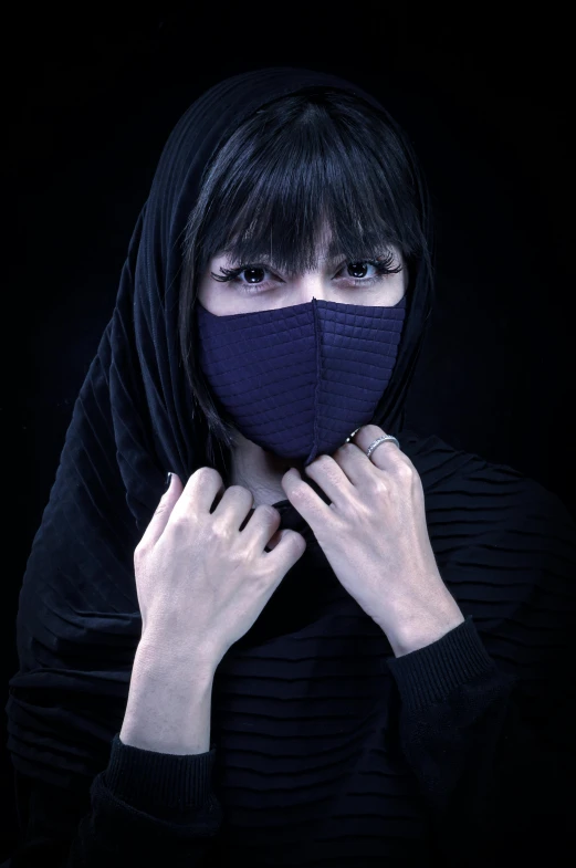 a young woman poses for a portrait in black hoodie