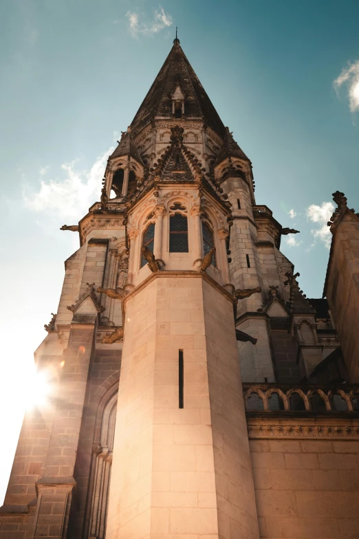 looking up at the top of a very tall building with an arched door