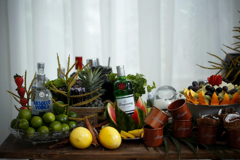 a table topped with fruit and drinks next to a window