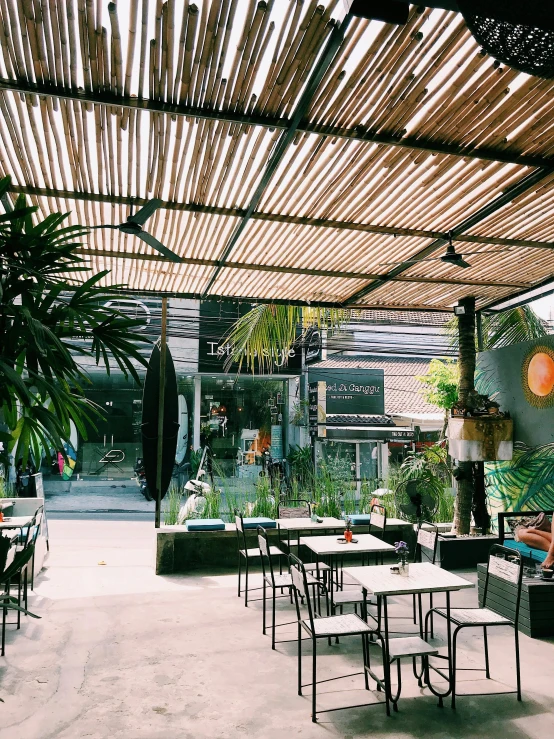 some tables and chairs under an umbrella