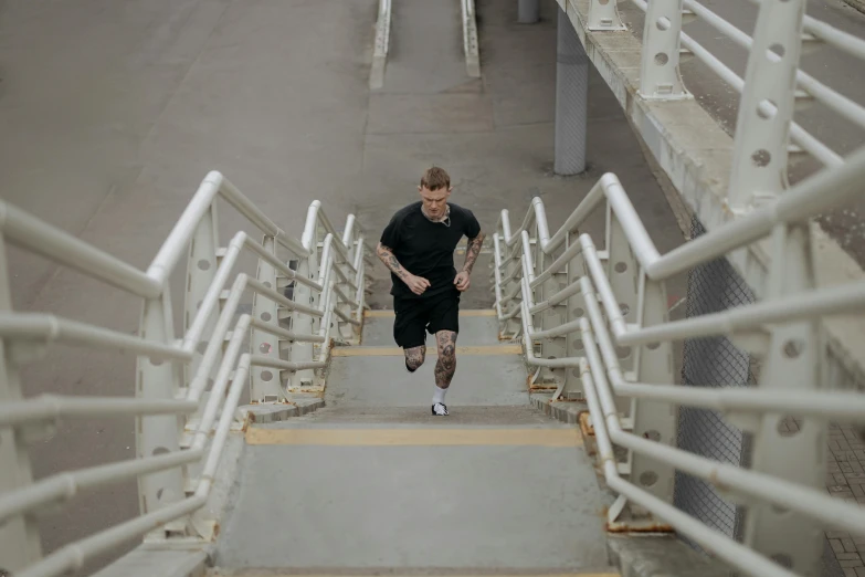 a person running on some stairs with his arms extended