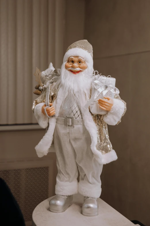 a man in a white outfit with a bag on top of a stool