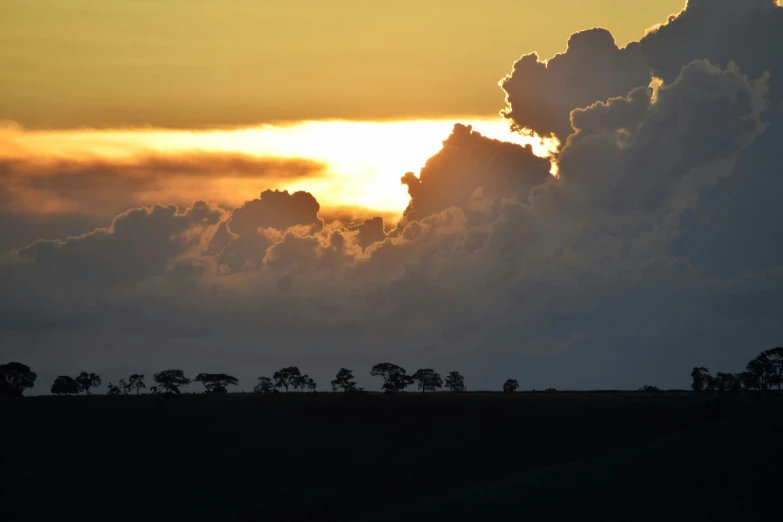 a view of the sun set from a field