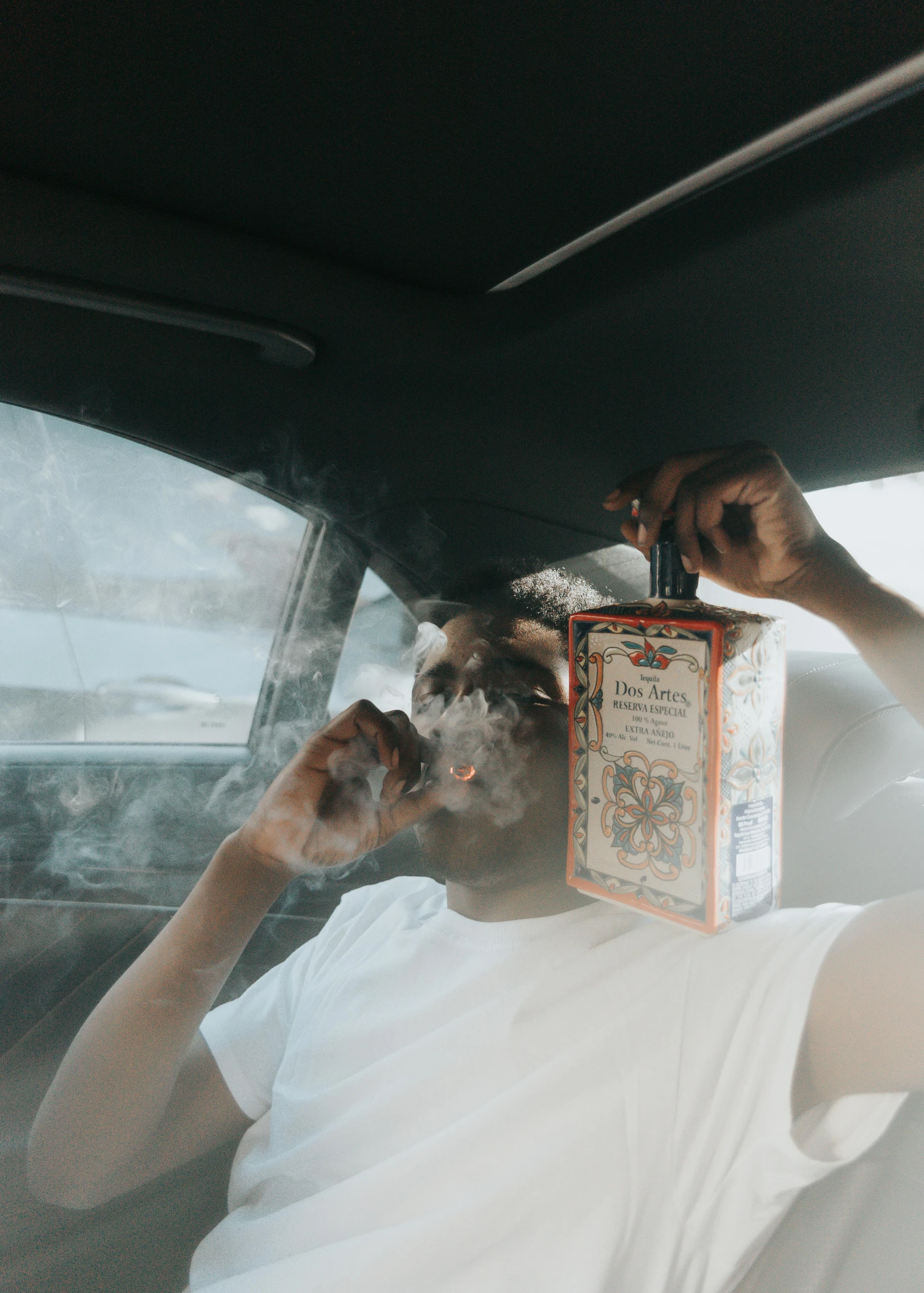 an image of a man sitting inside his car with a case