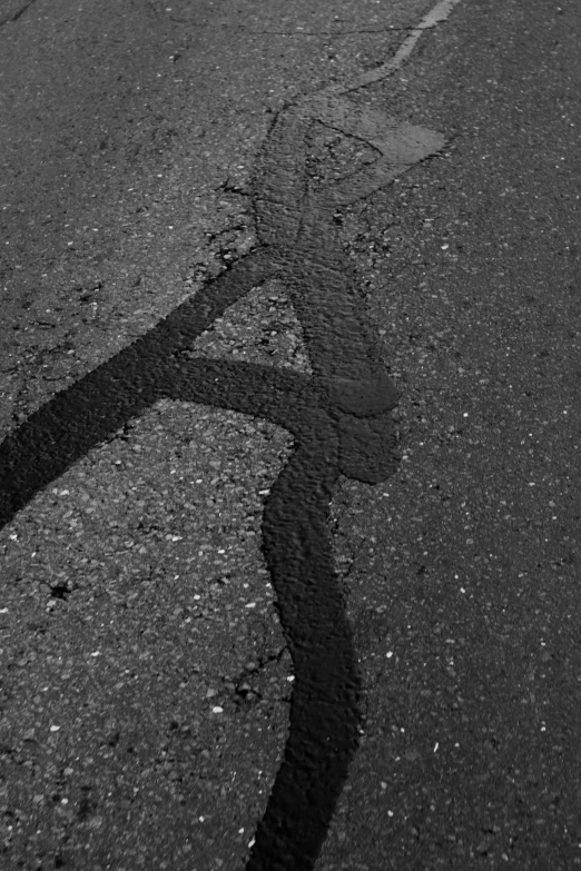 a long shadow of a stop sign sitting on the side of the road