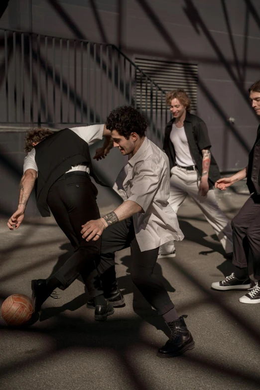 a group of men are playing a game of basketball