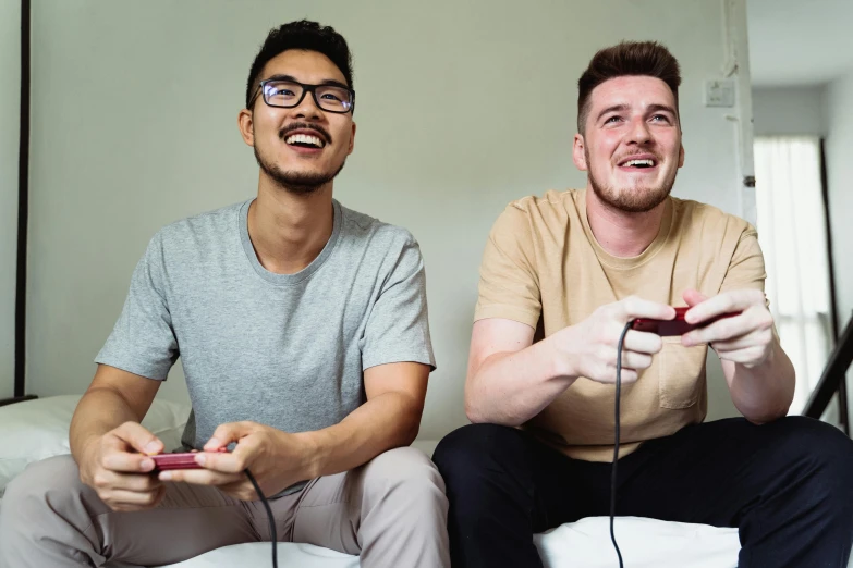 two men playing nintendo wii in their living room