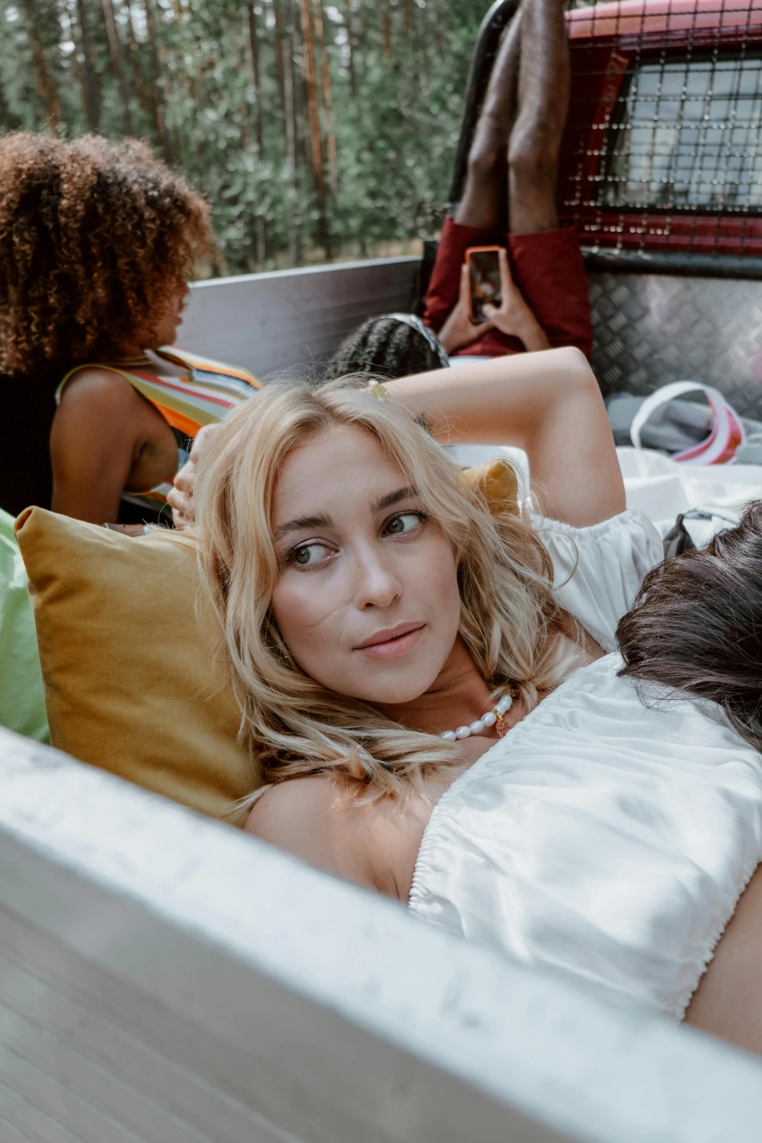 a woman lays in the back of a truck