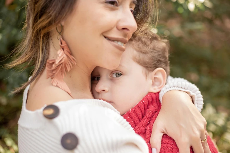 mother hugging her child in an emce outdoors