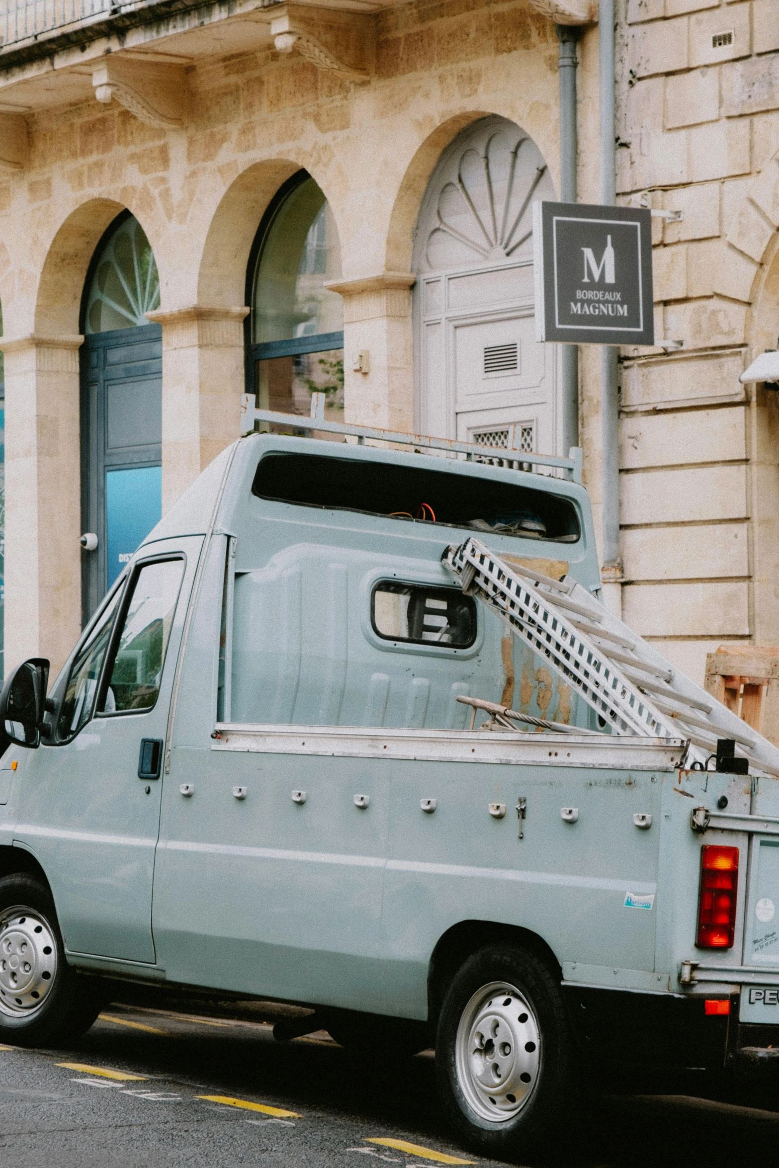 a blue truck parked next to a building