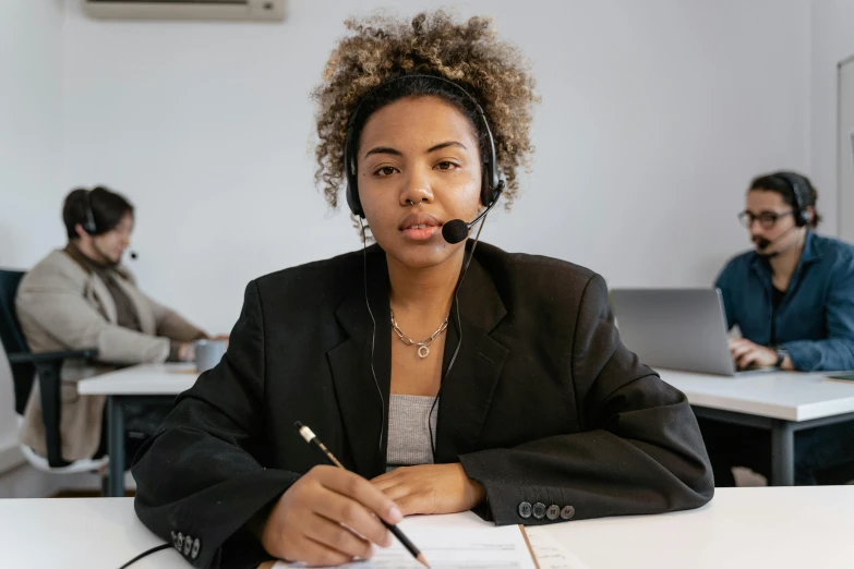 a woman wearing a headset is working on her computer