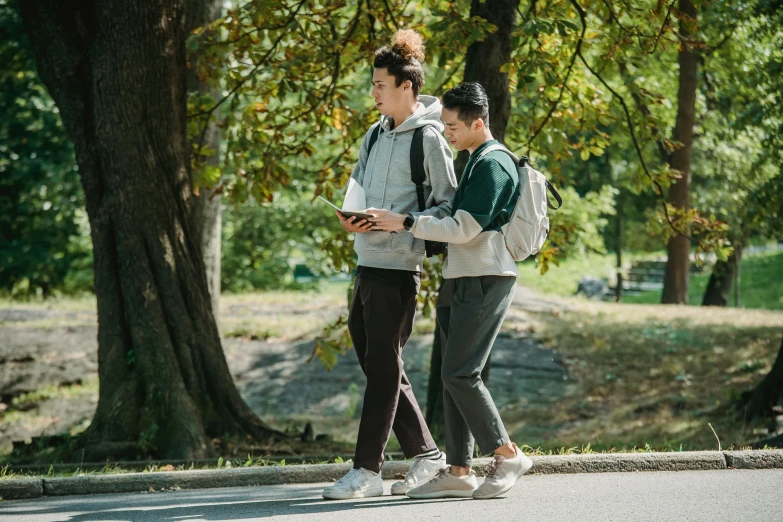 two people walk down the street while holding onto one another