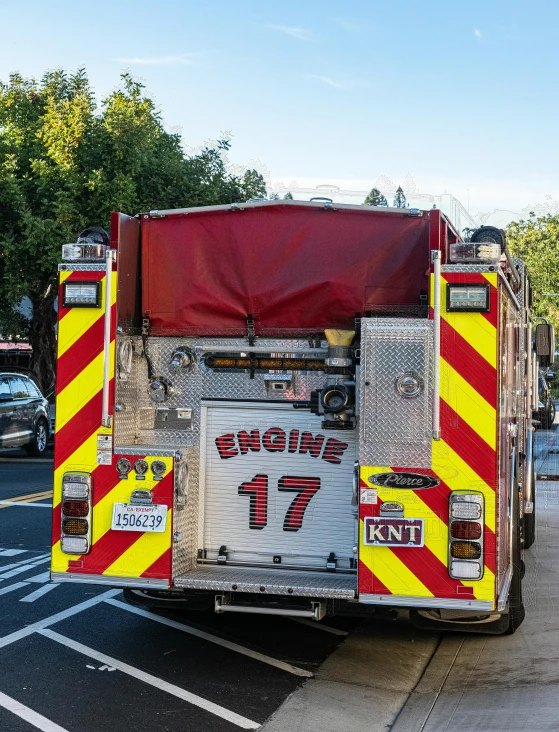 a red and yellow fire truck parked on a street