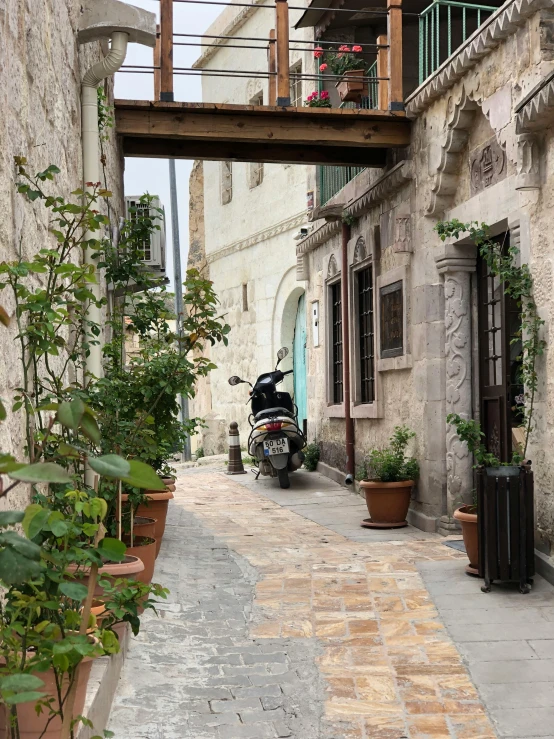 motorcycle parked in an alley surrounded by buildings