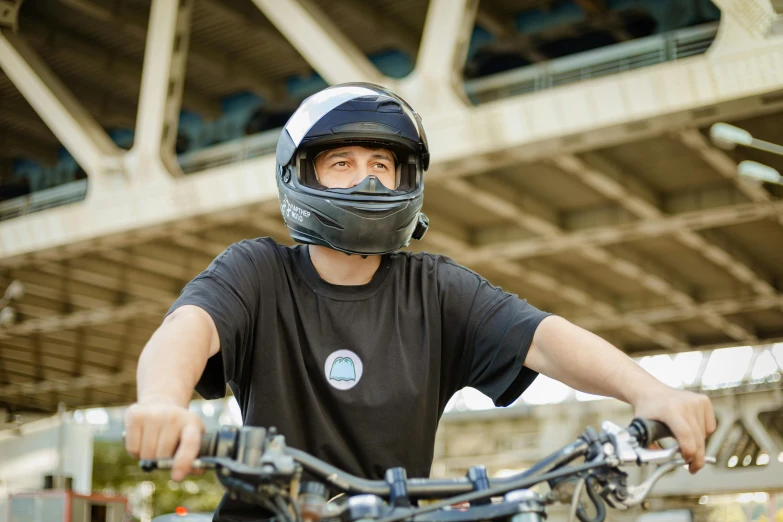 a young man in a helmet rides his bicycle