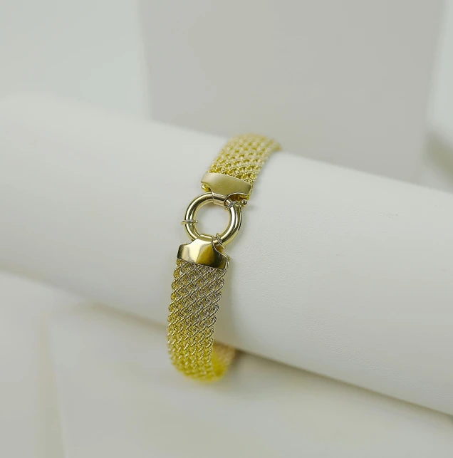 a gold colored metal celet with a loop and a circle on the clasp