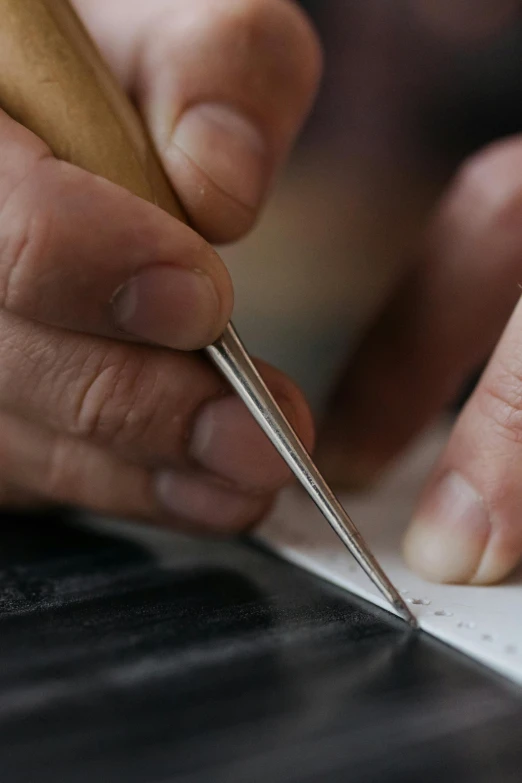 a close up of someone making a piece of paper with their hand