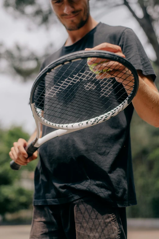 a man is holding a tennis racket