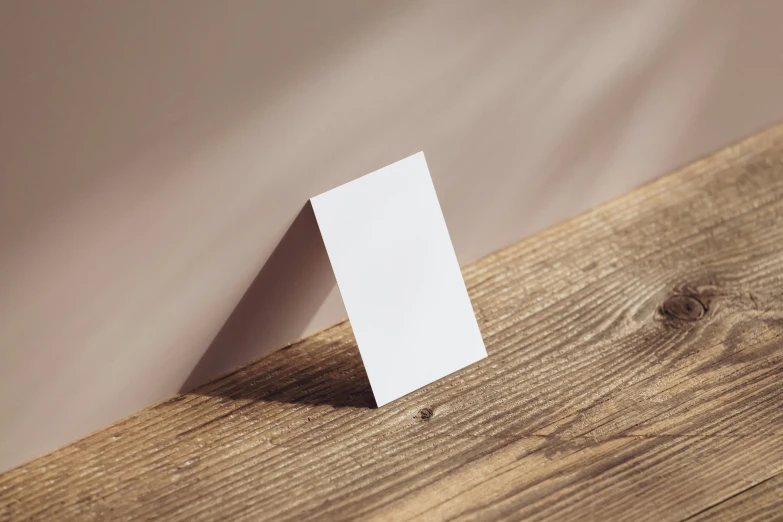 an item on a wooden floor with a piece of paper