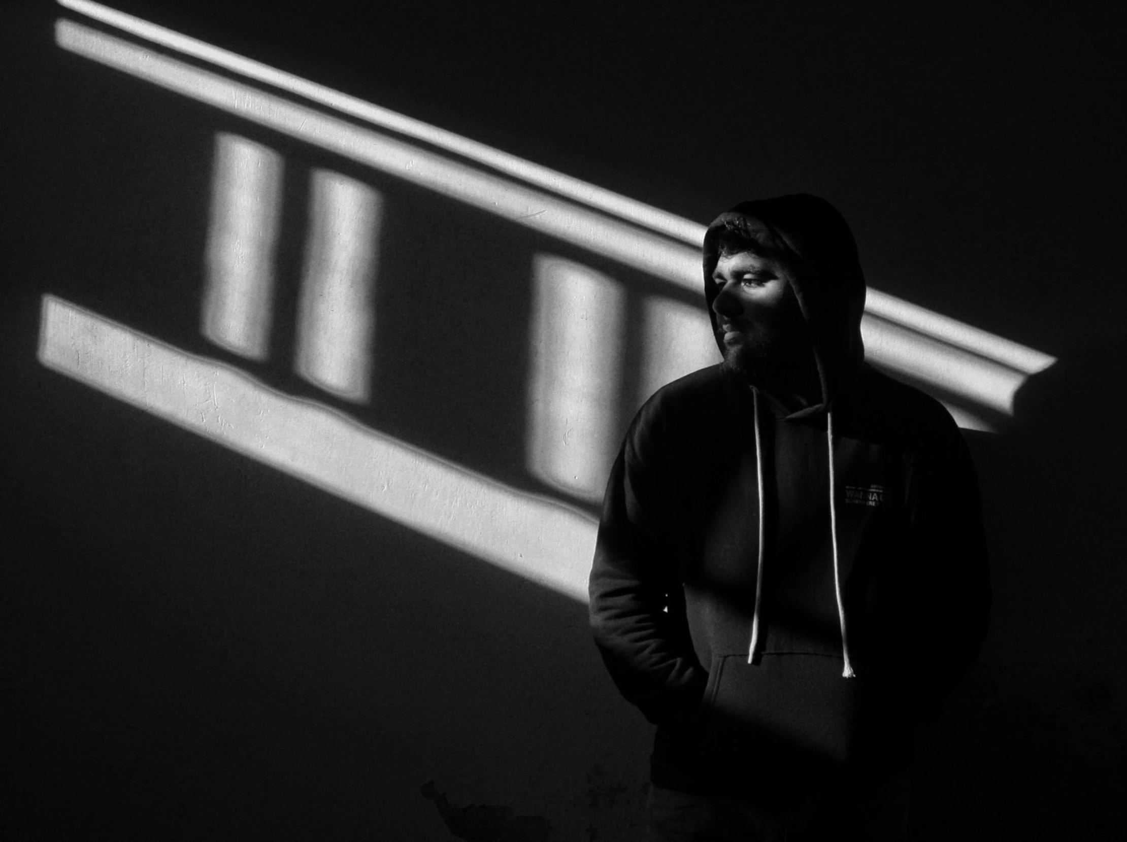 a man standing under a tall light on a dark street